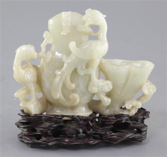 A Chinese pale celadon jade phoenix vessel, 18th / 19th century, 10.5 x 14.5cm, original carved wood stand, slight faults